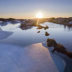 Low sun over a half frozen fjord Low sun over a half frozen fjord