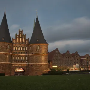 LUBECK, GERMANY - AUGUST 3, 2016: Holstentor Gate during twilight LUBECK, GERMANY - AUGUST 3, 2016: Holstentor Gate during twilight