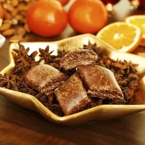 Magenbrot in a star shaped dish with Orange slices at back