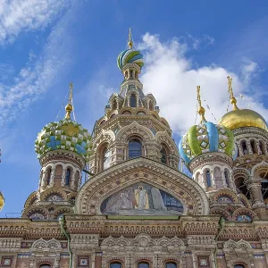 Magnificent cathedral with golden domes decorated with reliefs and ornate details