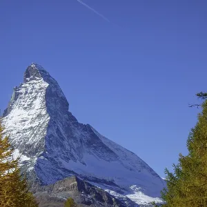 Majestic Matterhorn with snowy summit surrounded by autumn trees
