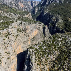 Majestic rock formations surrounded by green terrain and clear skies