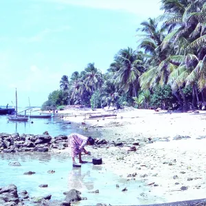 Maldives: Local woman on less idyllic beach Maldives: Local woman on less idyllic beach