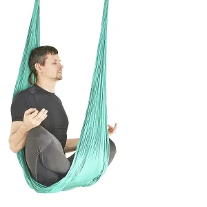 Male person do hammock yoga class exercise Male person do hammock yoga class exercise
