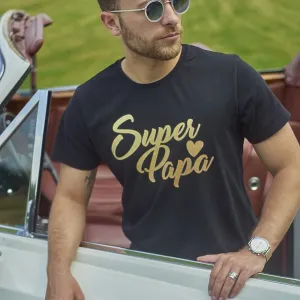 Man in a black shirt and sunglasses leaning against a white convertible in a green field