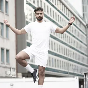 Man doing Yoga pose in city with Mudra hand sign