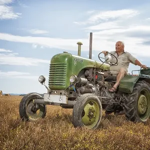 Man driving a Steyrer tractor, 15km/h Man driving a Steyrer tractor, 15km/h