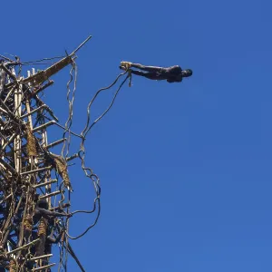 Man jumping from a bamboo tower Man jumping from a bamboo tower