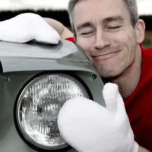 Man lovingly caring for his vintage car Man lovingly caring for his vintage car