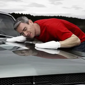 Man lovingly caring for his vintage car Man lovingly caring for his vintage car