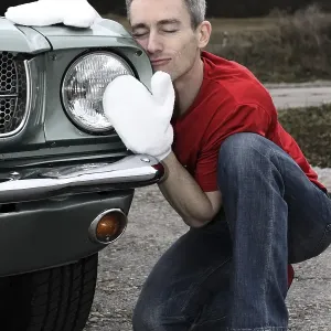 Man lovingly caring for his vintage car Man lovingly caring for his vintage car