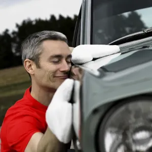Man lovingly caring for his vintage car Man lovingly caring for his vintage car