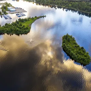 Man rowing a cayak at sunset, Lake Inari