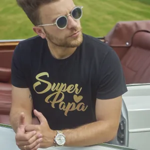 Man in sunglasses leaning casually on a convertible set against a scenic green field