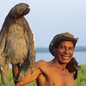 A man who runs a small private zoo near Iquitos on the Amazon shows a sloth A man who runs a small private zoo near Iquitos on the Amazon shows a sloth