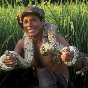 A man who runs a small private zoo near Iquitos on the Amazon shows two snakes A man who runs a small private zoo near Iquitos on the Amazon shows two snakes