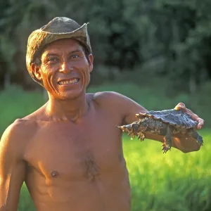 A man who runs a small private zoo near Iquitos on the Amazon shows a turtle A man who runs a small private zoo near Iquitos on the Amazon shows a turtle
