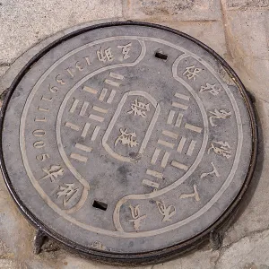 A manhole cover inscribed in Chinese in the courtyard of Kumbum Champa Ling Monastery