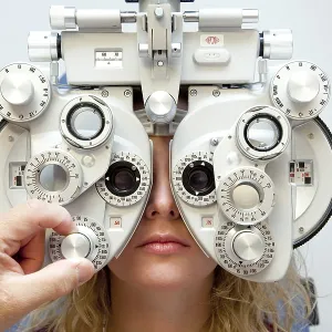 Measurement of the eyesight by using a phoropter to determine the prescription for glasses Measurement of the eyesight by using a phoropter to determine the prescription for glasses