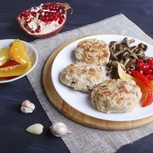 Meatballs with rice mushrooms, sweet peppers and pomegranate seeds on black wooden background Meatballs with rice mushrooms, sweet peppers and pomegranate seeds on black wooden background