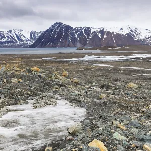 Melting glacier, rocks, water, mountain range Melting glacier, rocks, water, mountain range