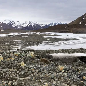 Melting glacier, rocks, water, mountain range Melting glacier, rocks, water, mountain range