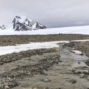 Melting glacier, stones, water Melting glacier, stones, water