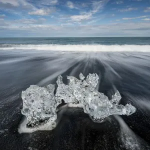 Melting iceberg lies in the surf Melting iceberg lies in the surf