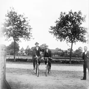 Men with bicycles, cyclists, hat, ca Men with bicycles, cyclists, hat, ca