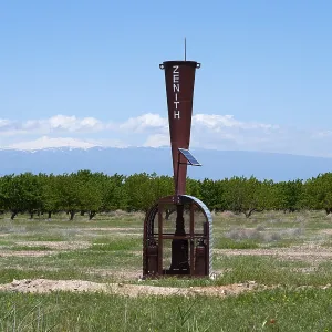 A meteorological device with a wide view of fields and mountains A meteorological device with a wide view of fields and mountains