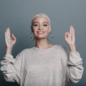 Millenial young european woman with short blonde hair portrait sitting Millenial young european woman with short blonde hair portrait sitting