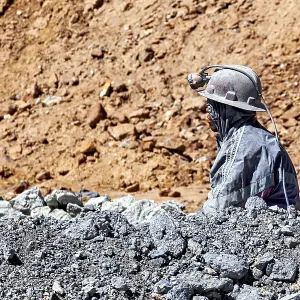 A miner gazes into the distance