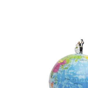 Miniature people wedding, bride and groom couple on The globe on white background Miniature people wedding, bride and groom couple on The globe on white background