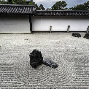 Minimalist zen garden with ornate sand patterns and rock groups Minimalist zen garden with ornate sand patterns and rock groups
