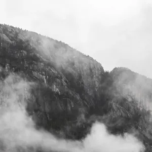 Misty clouds enveloping rugged mountains Misty clouds enveloping rugged mountains