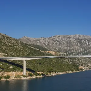Modern bridge across a river nestled in a mountainous landscape Modern bridge across a river nestled in a mountainous landscape