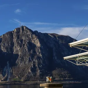 Modern Building Roof Against Blue Sky and Mountain Peak San Salvatore on Lake Lugano in Campione d'Italia Modern Building Roof Against Blue Sky and Mountain Peak San Salvatore on Lake Lugano in Campione d'Italia