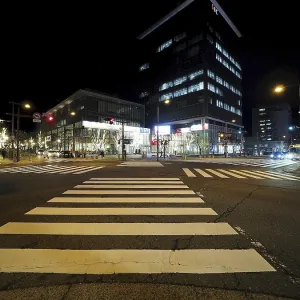 Modern buildings light up a nocturnal intersection full of lights