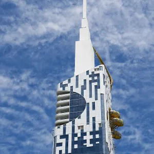 Modern high-rise building with distinctive design against a blue sky