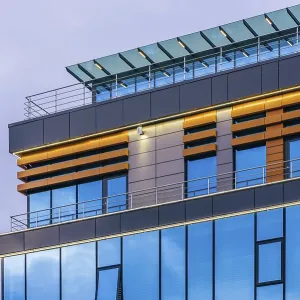 Modern high-rise office building with a glass facade at overcast Modern high-rise office building with a glass facade at overcast