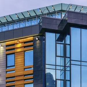 Modern high-rise office building with a glass facade at overcast Modern high-rise office building with a glass facade at overcast