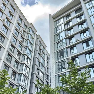 Modern high-rise residential buildings with reflective glass windows and air conditioners