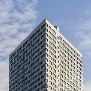 Modern Skyscraper on the Cloudy Sky Background Modern Skyscraper on the Cloudy Sky Background