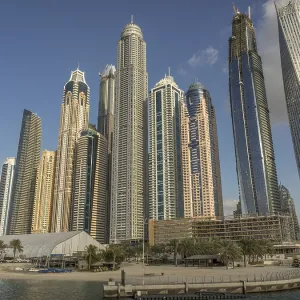 Modern skyscrapers on harbor with blue sky and water
