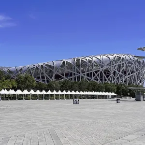 A modern stadium with distinctive architecture under a clear blue sky A modern stadium with distinctive architecture under a clear blue sky