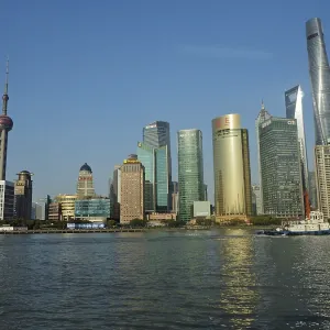 Modern urban skyline of Huangpu Jiang on the water under clear blue sky