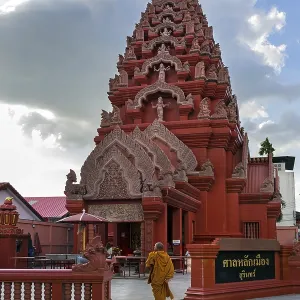 Monk in front of the Khmer-style City Pillar Lak Muang