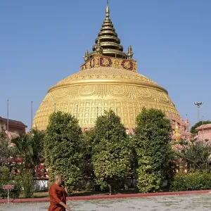 Monk walking in front of stupa at Sitagu International Buddhist Academy