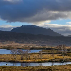 Moor landscape with cloudy sky and mountains in the background Moor landscape with cloudy sky and mountains in the background