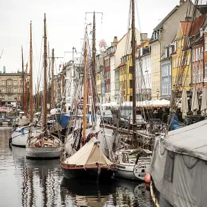 Mooring of several sailboats along a quay with bright Mooring of several sailboats along a quay with bright